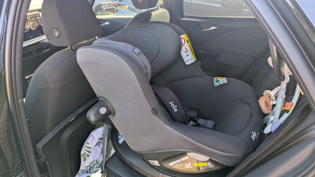 Dark grey Joie i-Spin 360 car seat rotated sideways inside a Volkswagen ID.3 electric car after 10 months of daily use.