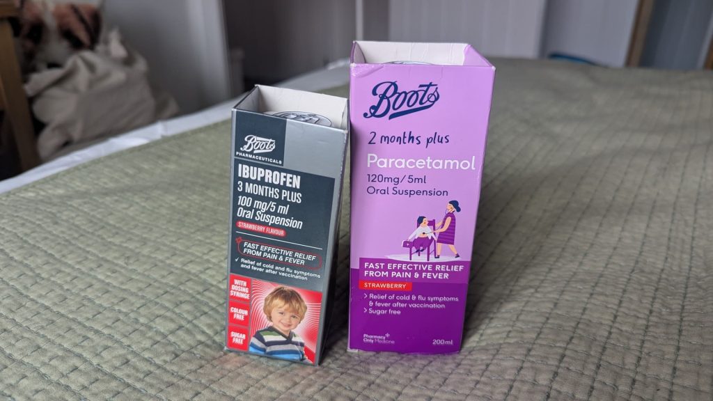 Boxes of Boots infant paracetamol and ibuprofen oral suspension sitting on a bed.
