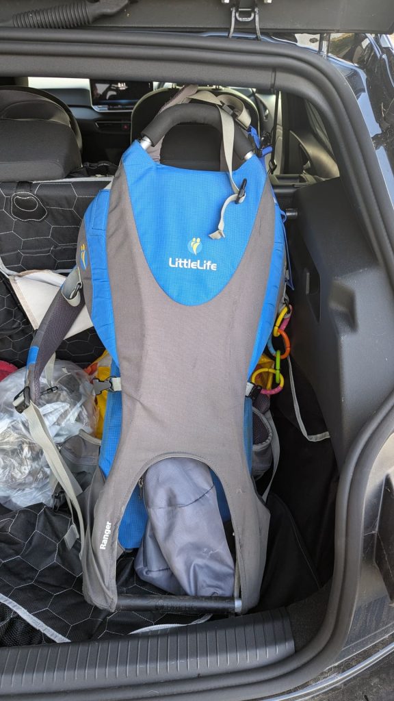 Blue Littlelife Ranger child carrier review model standing upright inside the boot of a Hyundai Bayon.